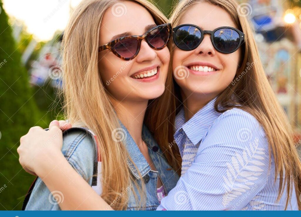 una imagen de dos amigas sonriendo y abrazandose felizmente