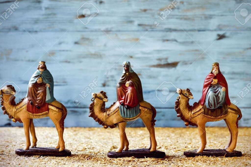 una imagen de los reyes magos montados en camellos viajando por el desierto