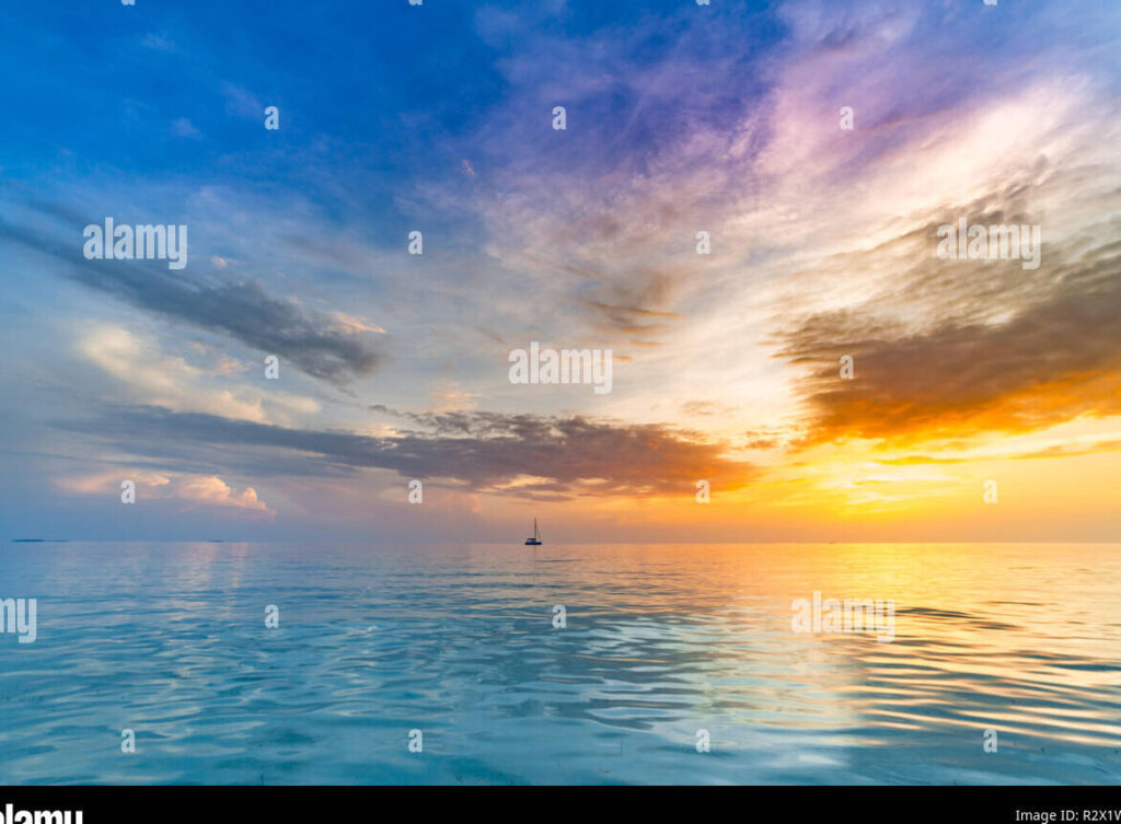 una imagen de un paisaje marino con colores vivos y un sol radiante en el horizonte