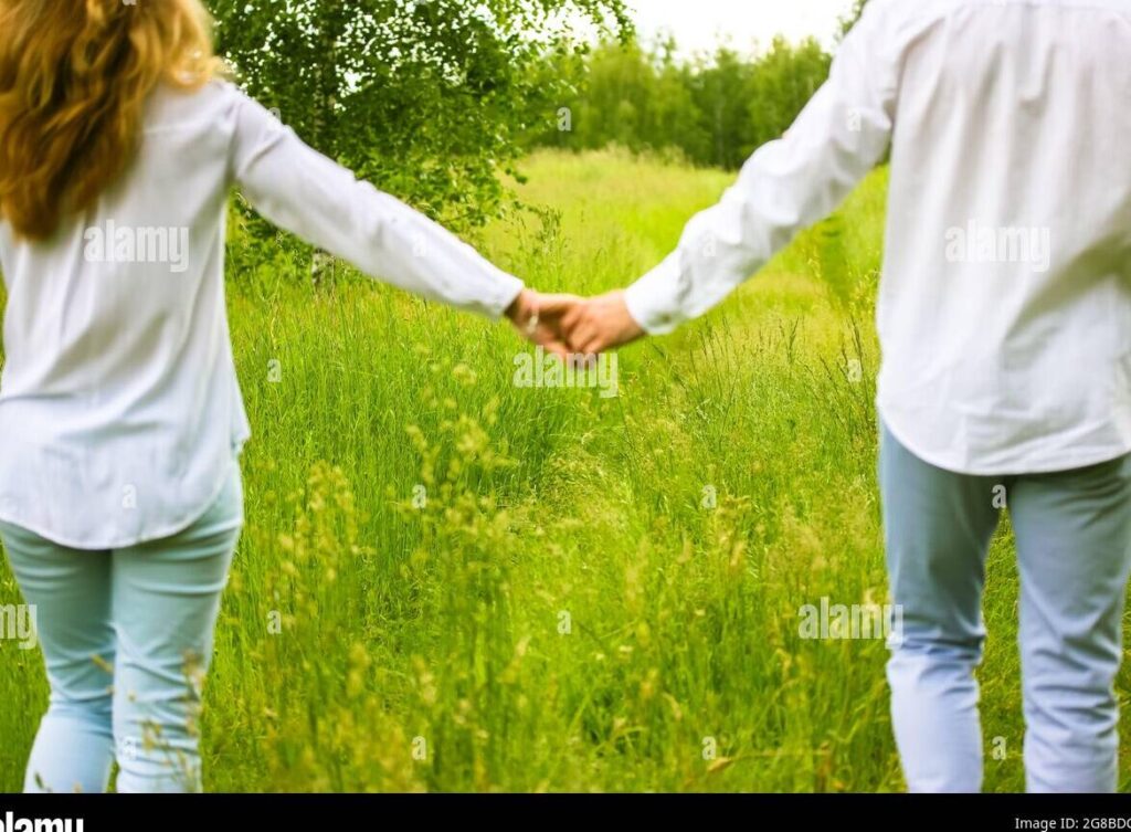 una pareja feliz tomados de la mano en un hermoso paisaje natural